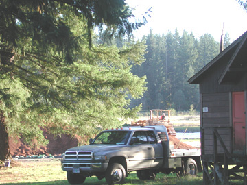 Camp BonnevilleContaminatedsoilpiledintrucks Contaminated soil is piled high in a field, where it is sifted and made ready for transport with heavy machinery.